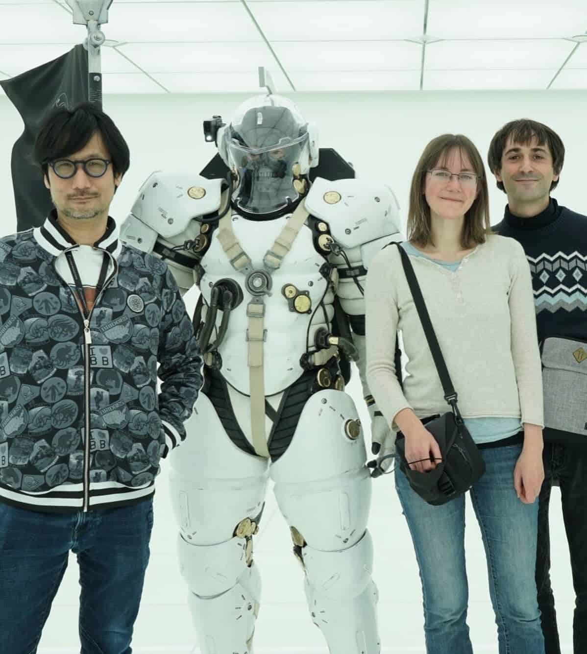 Cécile Brun and Olivier Pichard of Atelier Sentô next to Hideo Kojima and a character in a white armed jumpsuit.