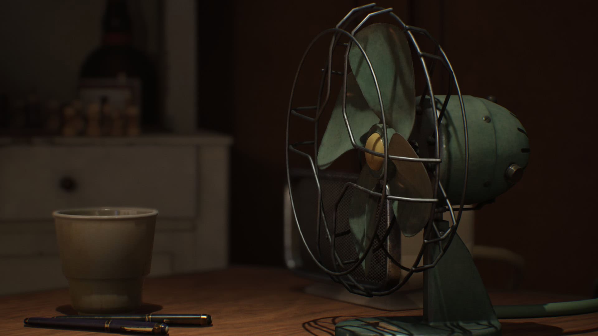 A vintage green fan on a table with a pen and glass, in a scene from Lost & Found: A This Bed We Made Story.