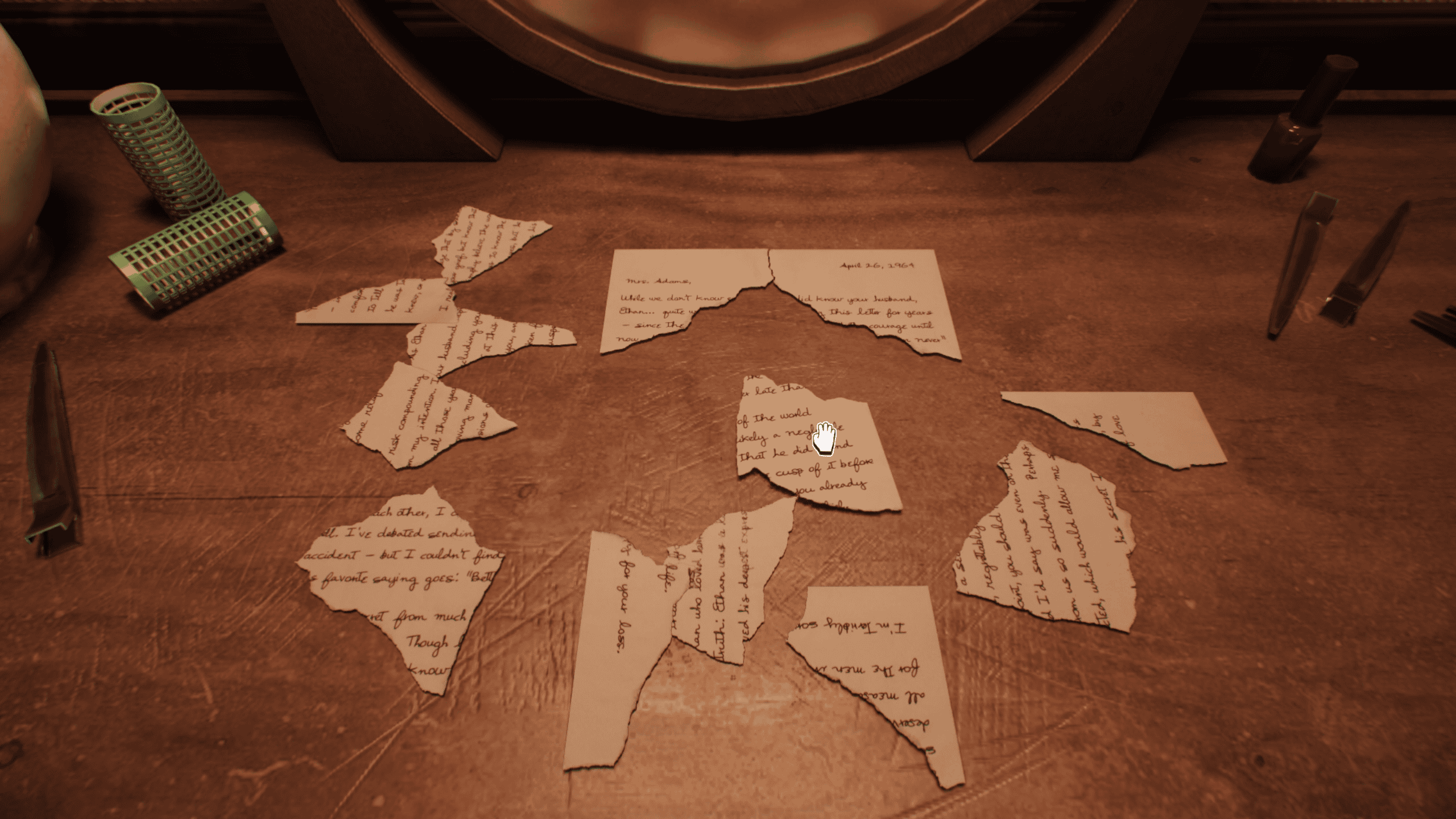 Pieces of a torn letter reconstructed on a table in Lost & Found: A This Bed We Made Story.